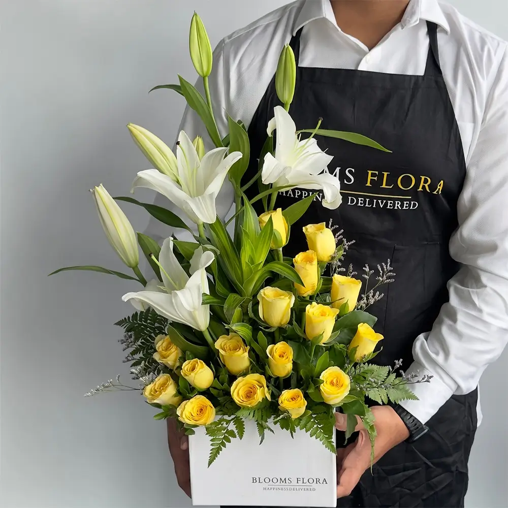 2 white lilies and 16 yellow roses in a white box