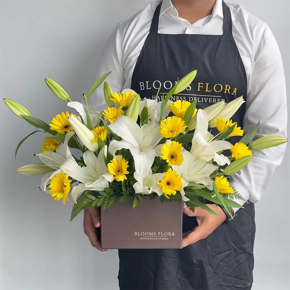 5 white lilies and 15 yellow gerberas in brown box