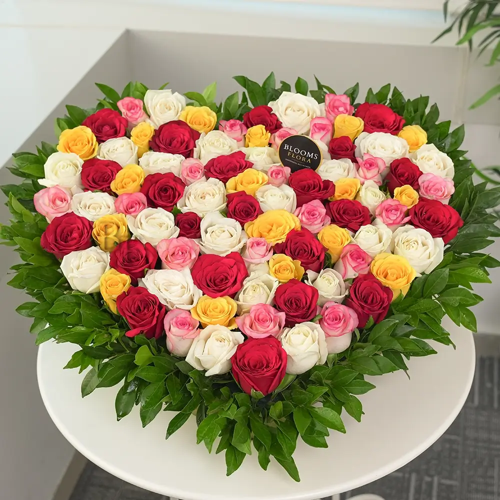 50 mixed roses heart shape arrangement in pink, yellow, white and red – romantic anniversary and Valentine's Day gift, same-day delivery India
