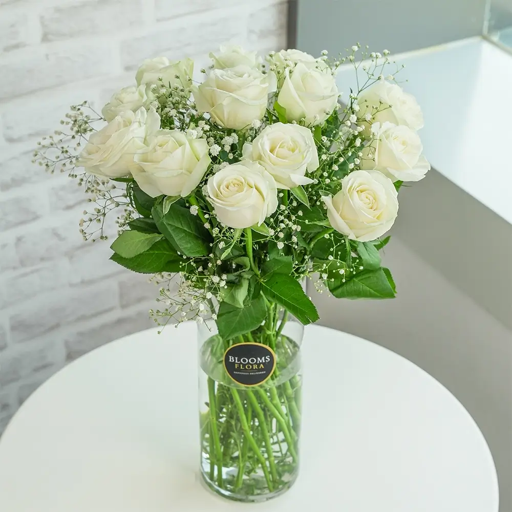 12 white roses in a vase