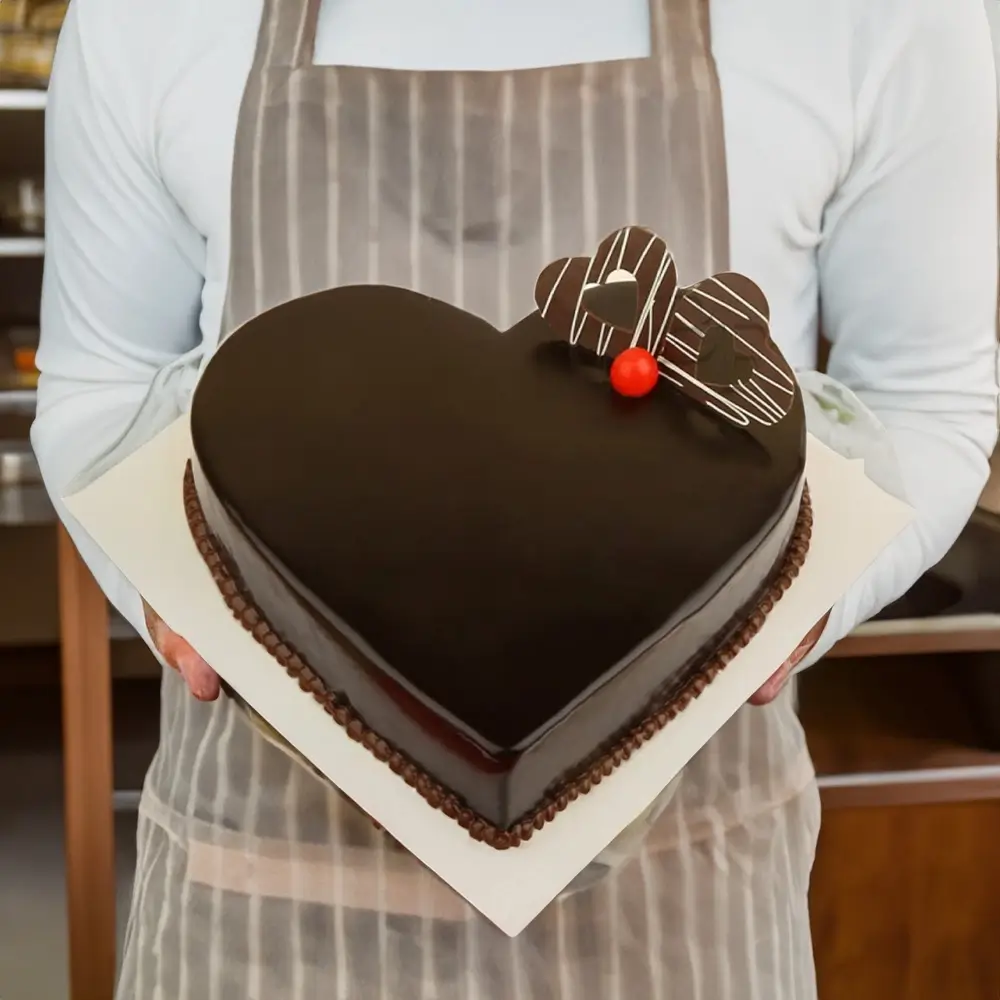 1 kg heart shaped chocolate truffle cake – Romantic heart-shaped chocolate cake adorned with luscious truffles, perfect for Valentine's Day and special occasions.