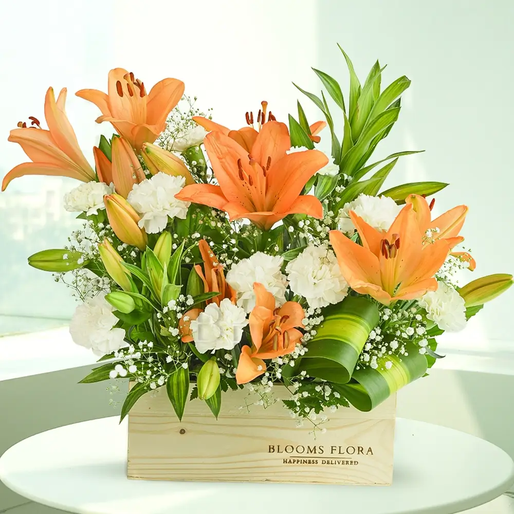 10 white carnations and 4 orange lilies in a wooden box