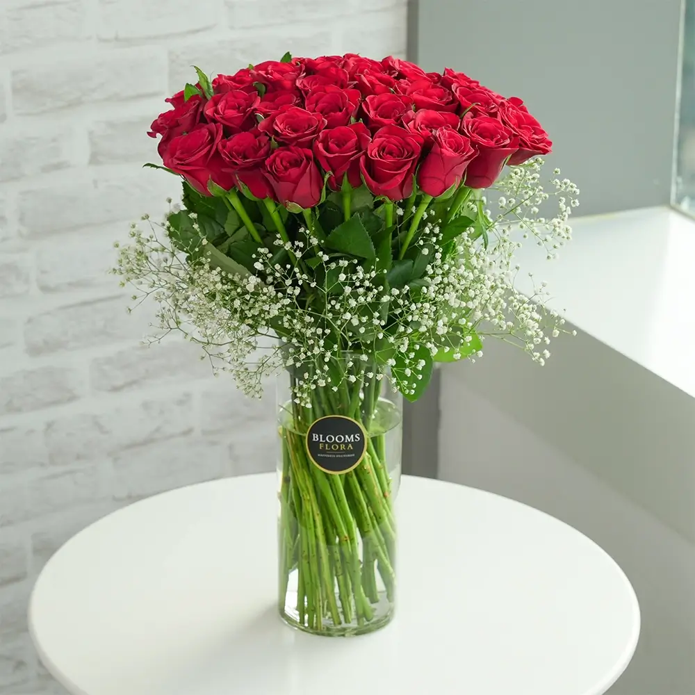 40 red roses in a glass vase