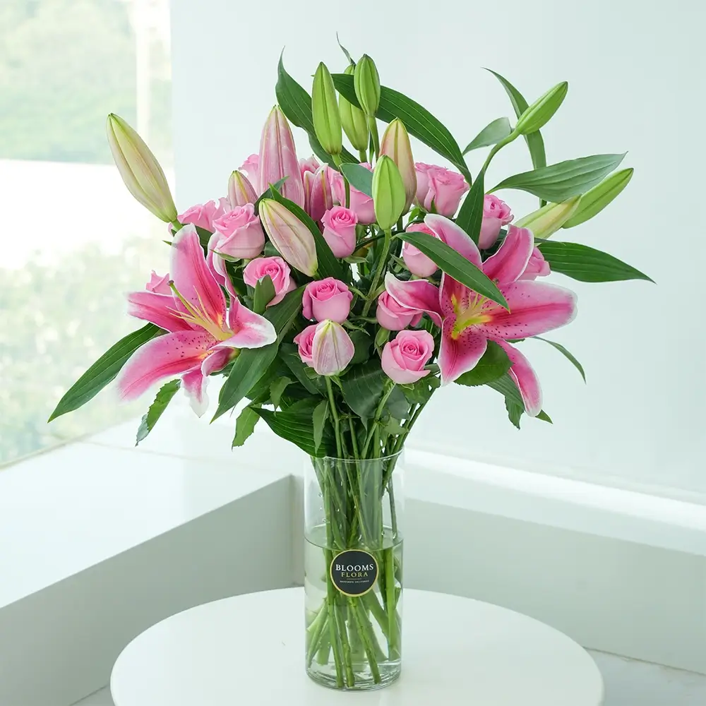 A vase of 20 pink roses and 4 pink lilies