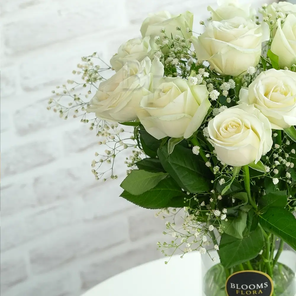 12 white roses in a vase