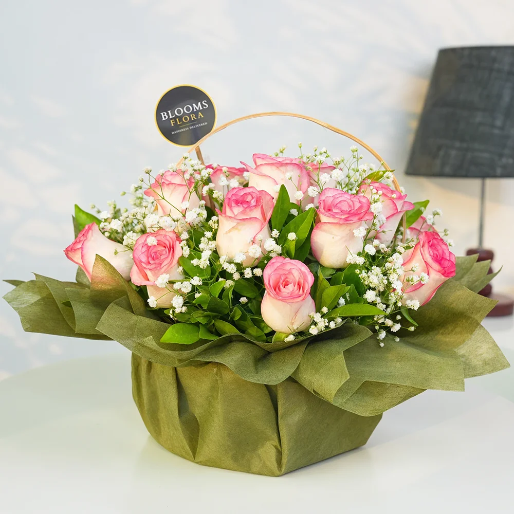12 pink roses in a basket